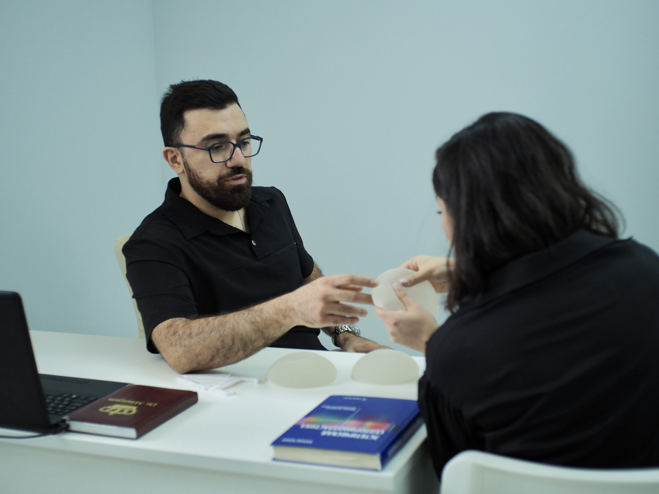 Пластический хирург Паруйр Минасян с пациенткой на консультации по увеличению груди